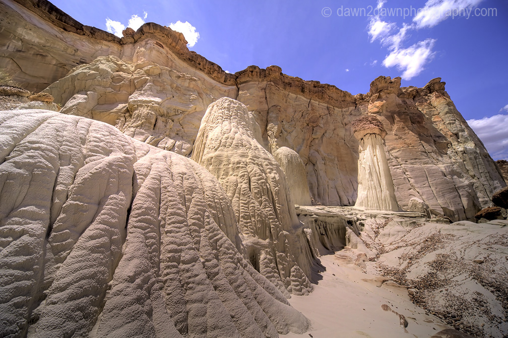 Sandstone walls and hoodoos carved through erosion make up the landscape at Wahweap Creek near Big Water, Utah
