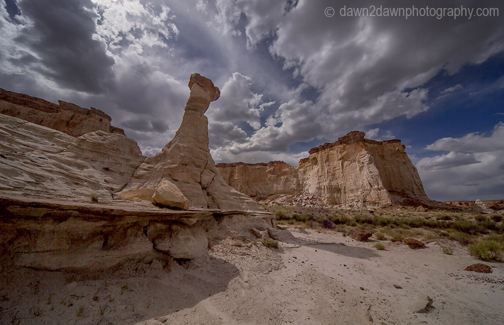 Sandstone walls and hoodoos carved through erosion make up the landscape at Wahweap Creek near Big Water, Utah