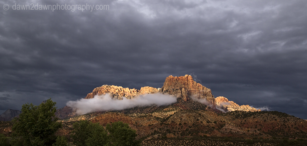 Passing storms bring rain and fog to the steep sandstone canyon walls at Zion National Park, Utah