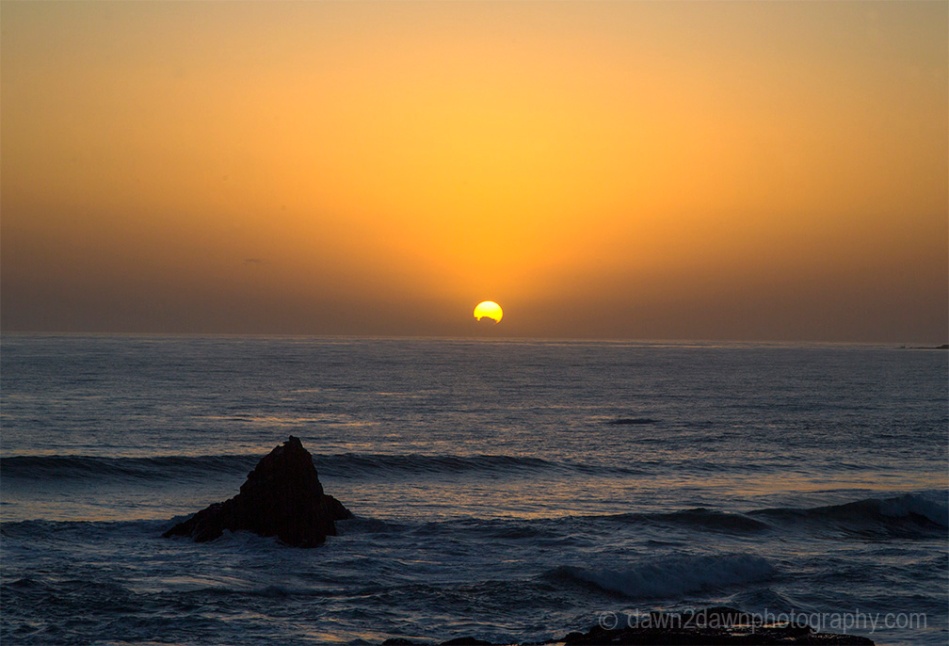 The sun sets on California's Pacific Ocean at San Simeon.