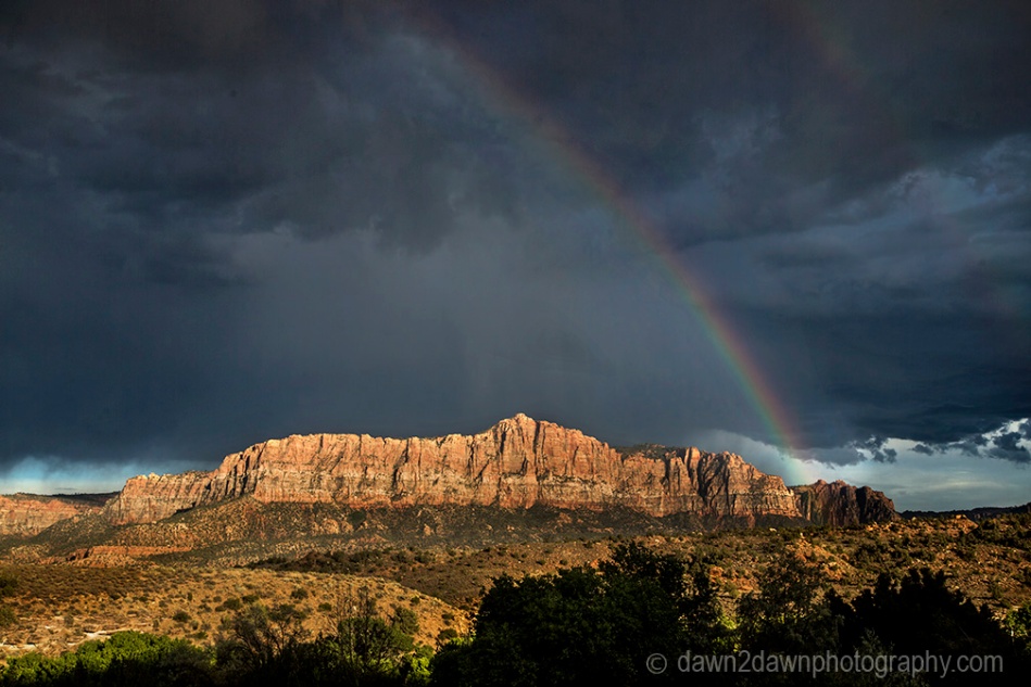 A rainbow appears during a thunderstorm at Zion National Park, Utah