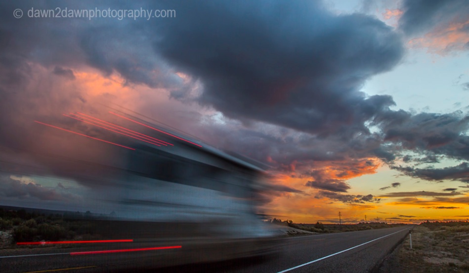 A motor home drives towards the setting sun in Southern Utah