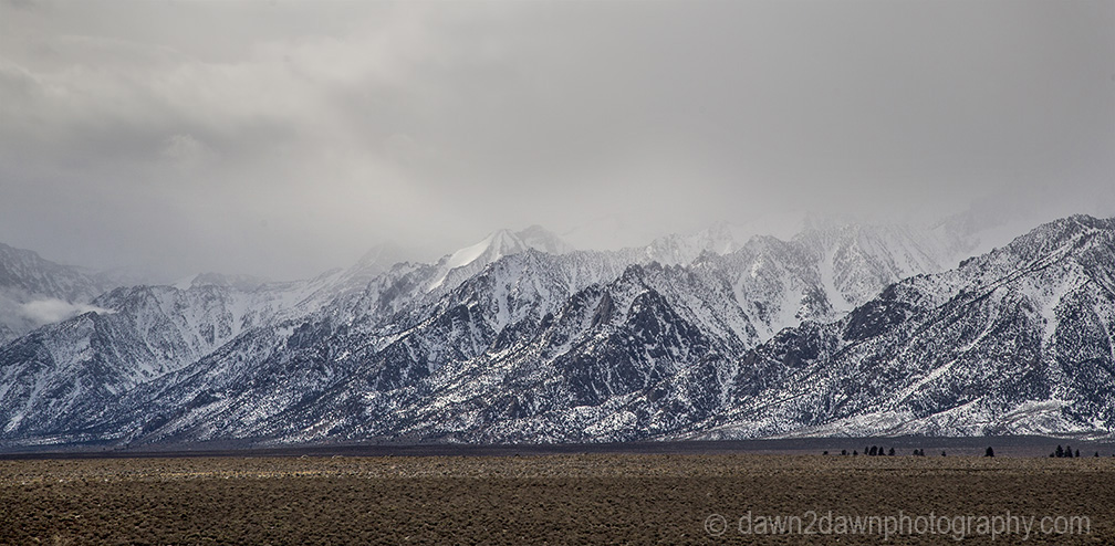 The snow-covered Sierra Nevada Mountains are the predominate feature at Owens Valley, California