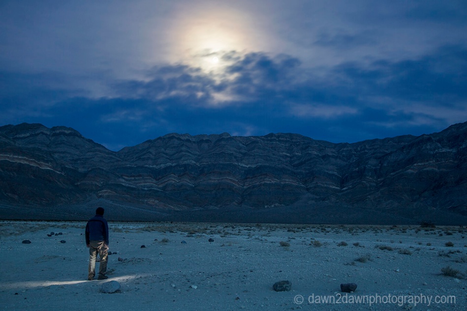 A nearly full moon rises over the Last Chance Mountains at Death Valley National Park, California