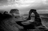 Delicate Arch stands prominent during threatening skies at Arches National Park, Utah